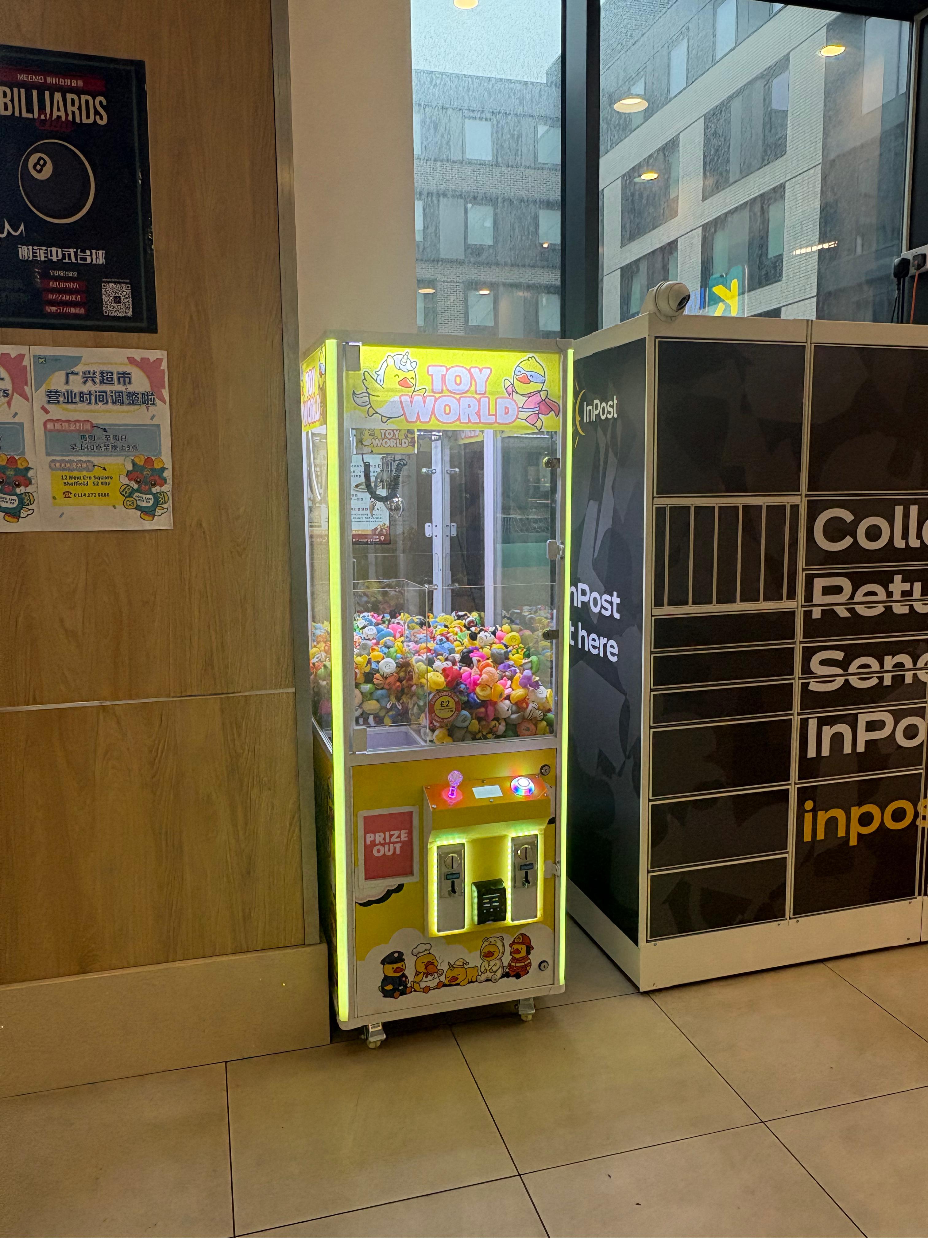 A Toy World claw machine in a shop entrance