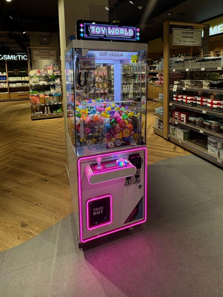 A Toy World claw machine in a homeware retail store
